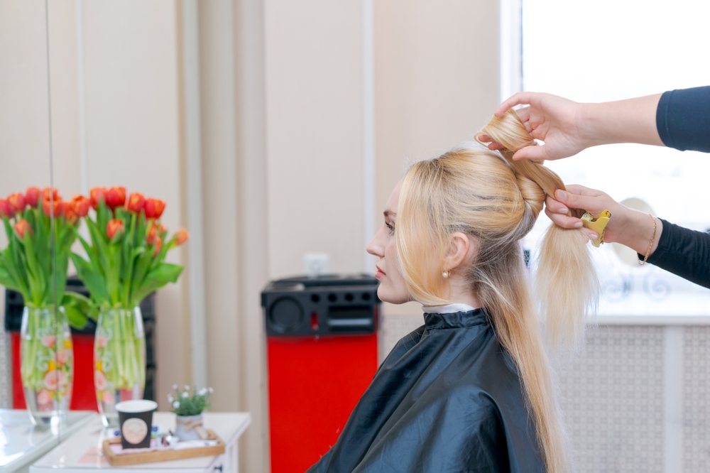 Autistic woman faces intense, silent stare down with reflection during haircut