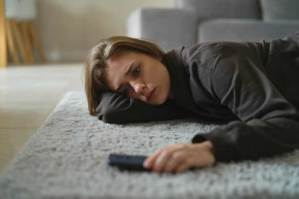 Person lying on the floor with their phone